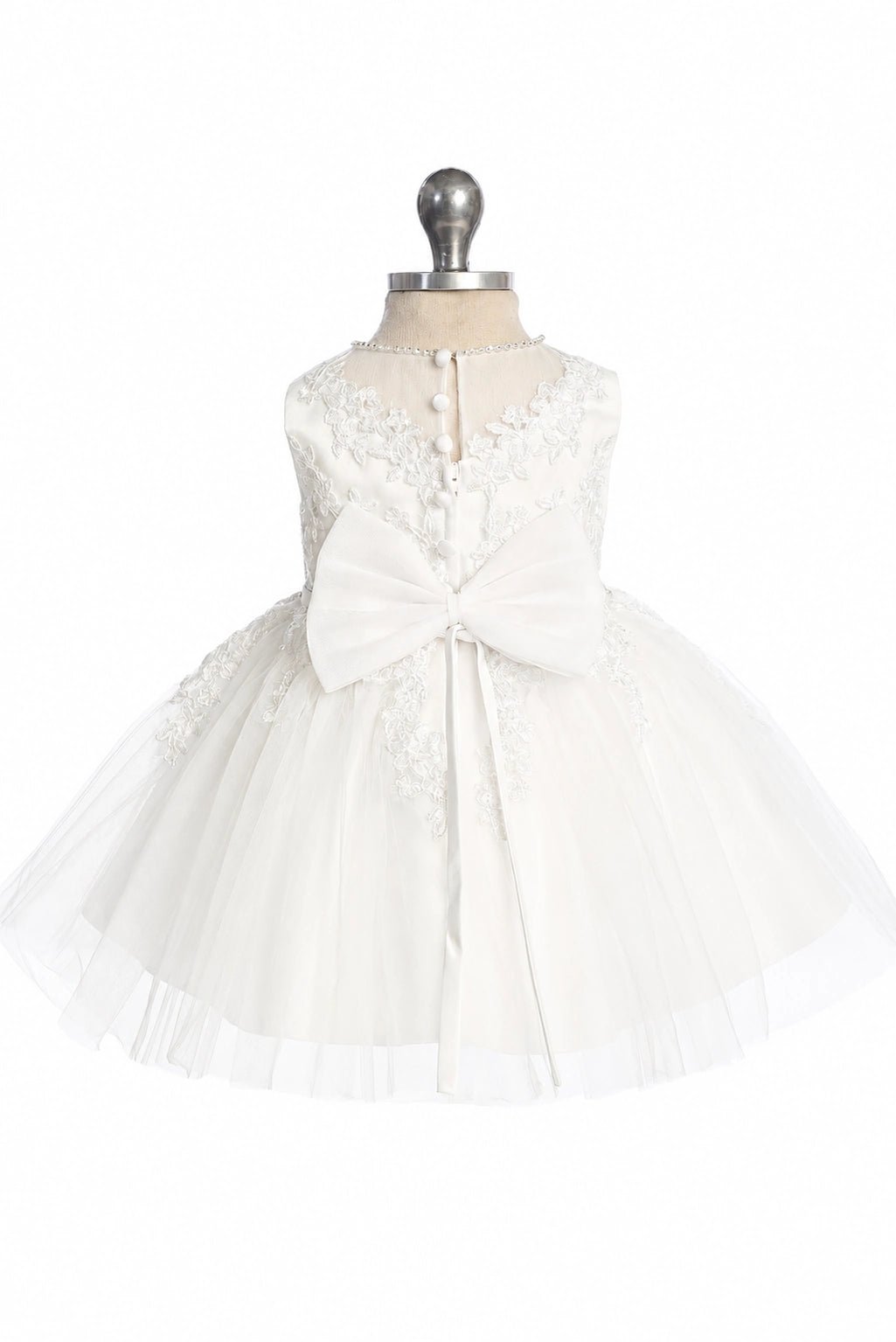 Featuring a narrow rear lace opening, an off-white flower girl dress.
