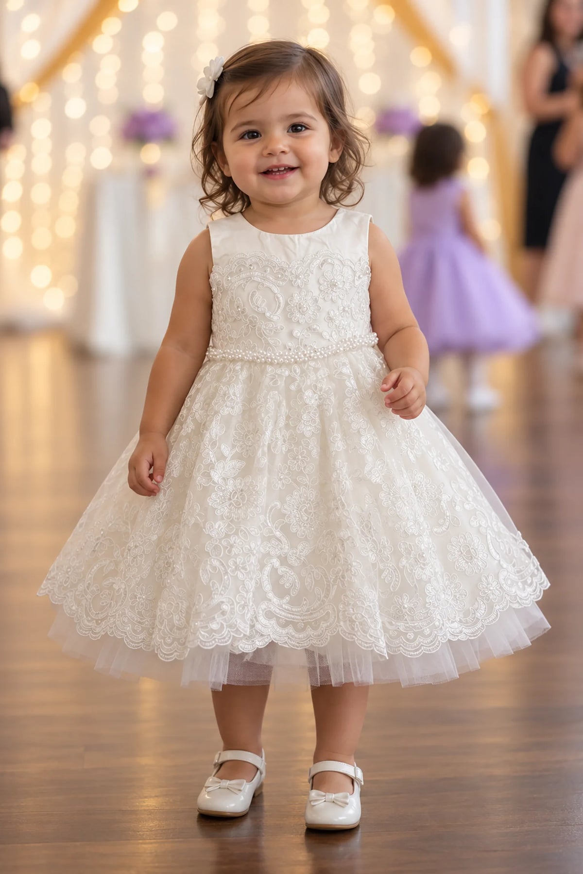 Ivory flower girl dress with floral lace and a pearl waistband.