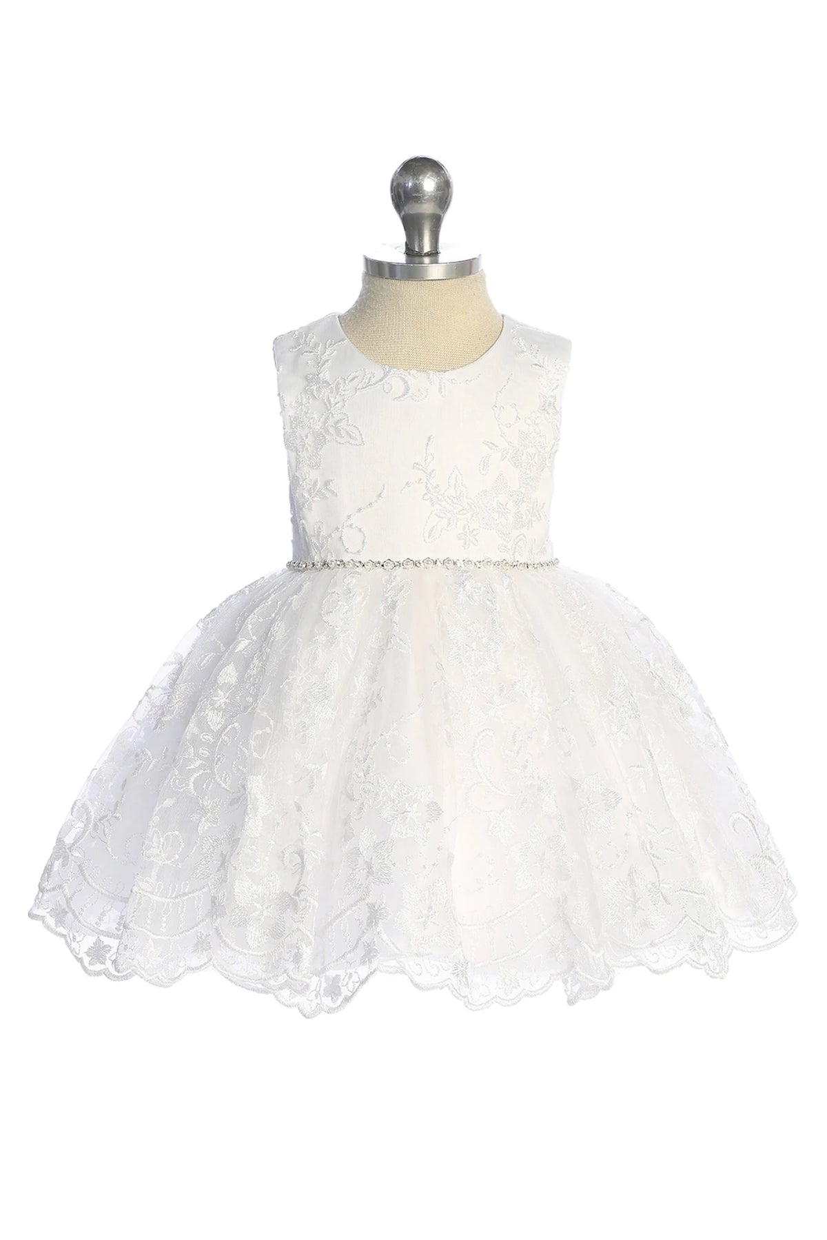Scalloped lace hem: detail of the white flower girl dress.