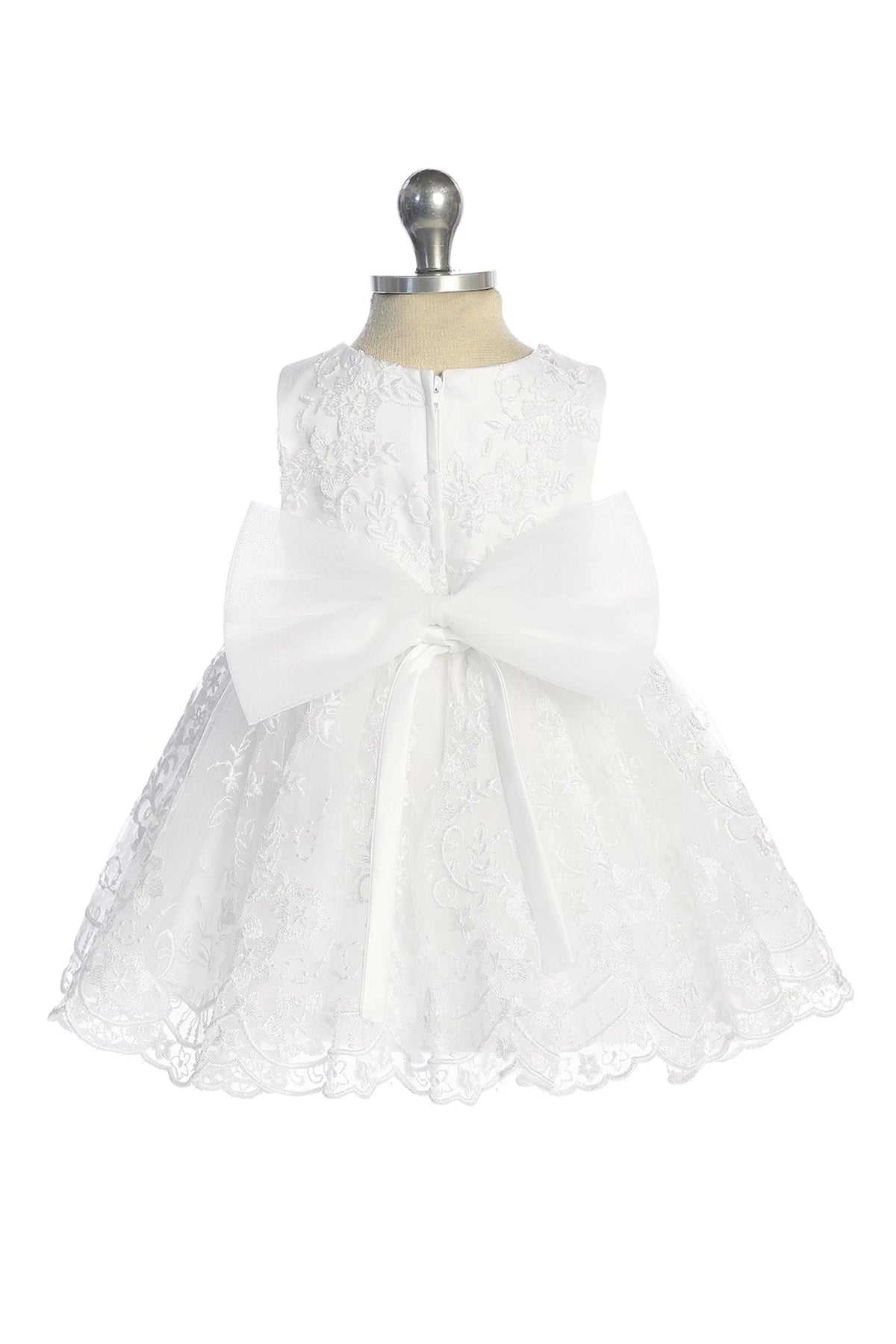 White flower girl dress featuring a large satin back bow.