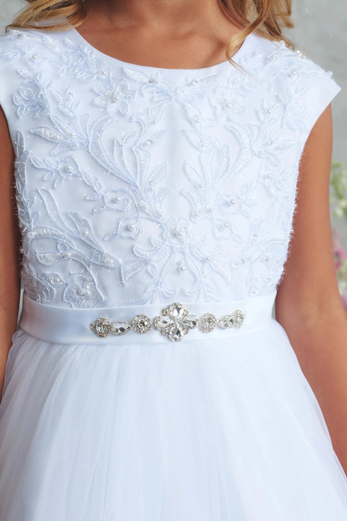Floral lace bodice on a white flower girl dress.