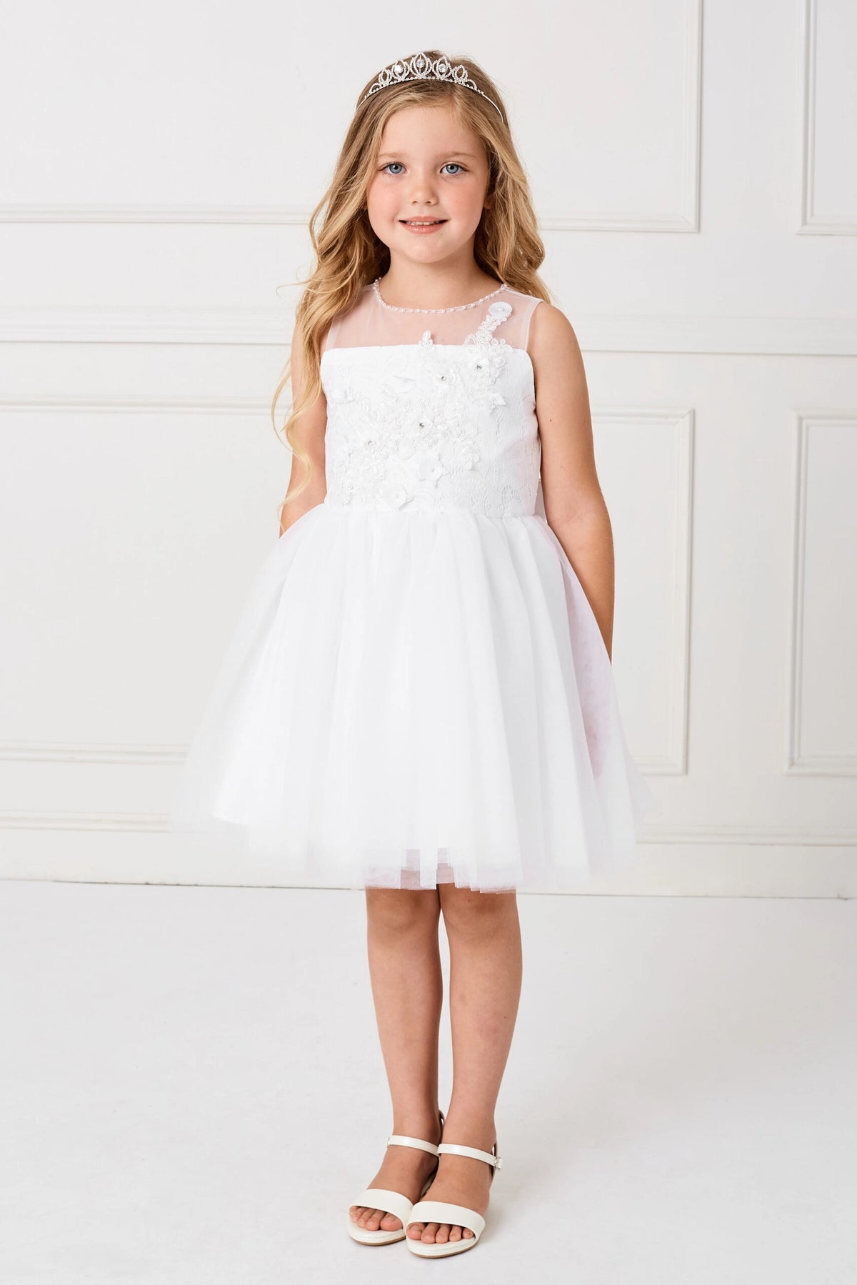 Full soft tulle skirt accents the white flower girl dress.