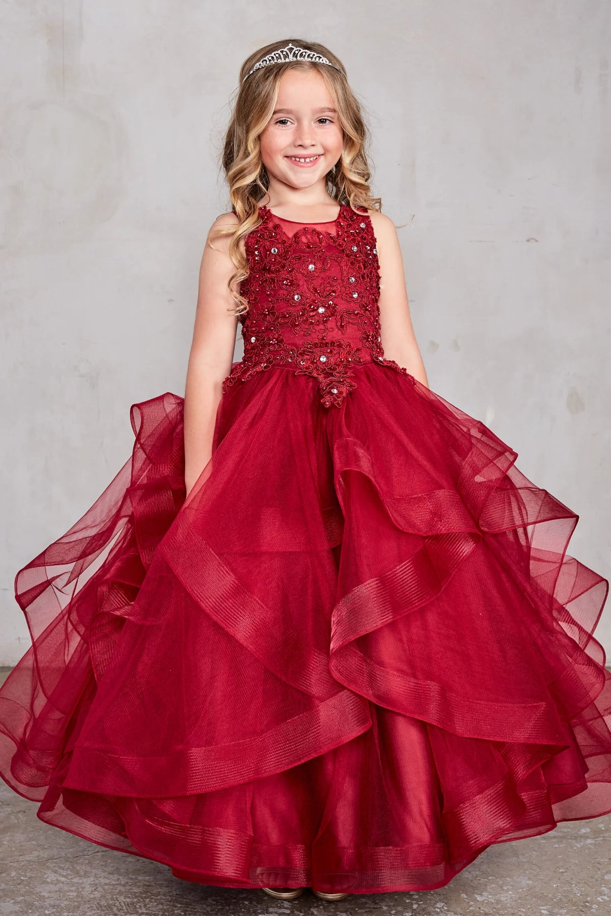 Burgundy kids pageant dress featuring a lace bodice and tiered mesh skirt.