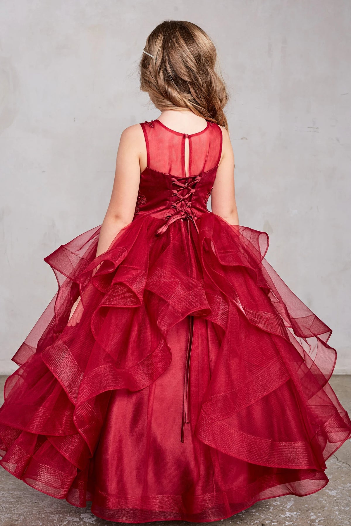 The Burgundy kids pageant dress has lace-up ties at the back.