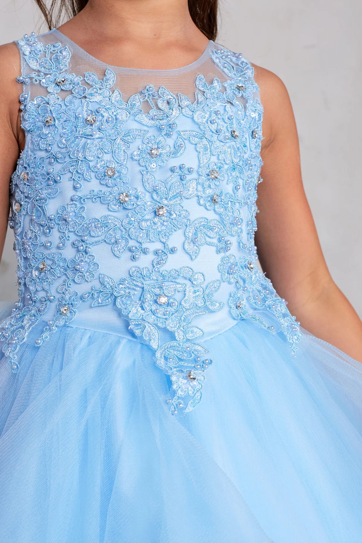 The Sky Blue kids pageant dress has floral lace at the upper waist.