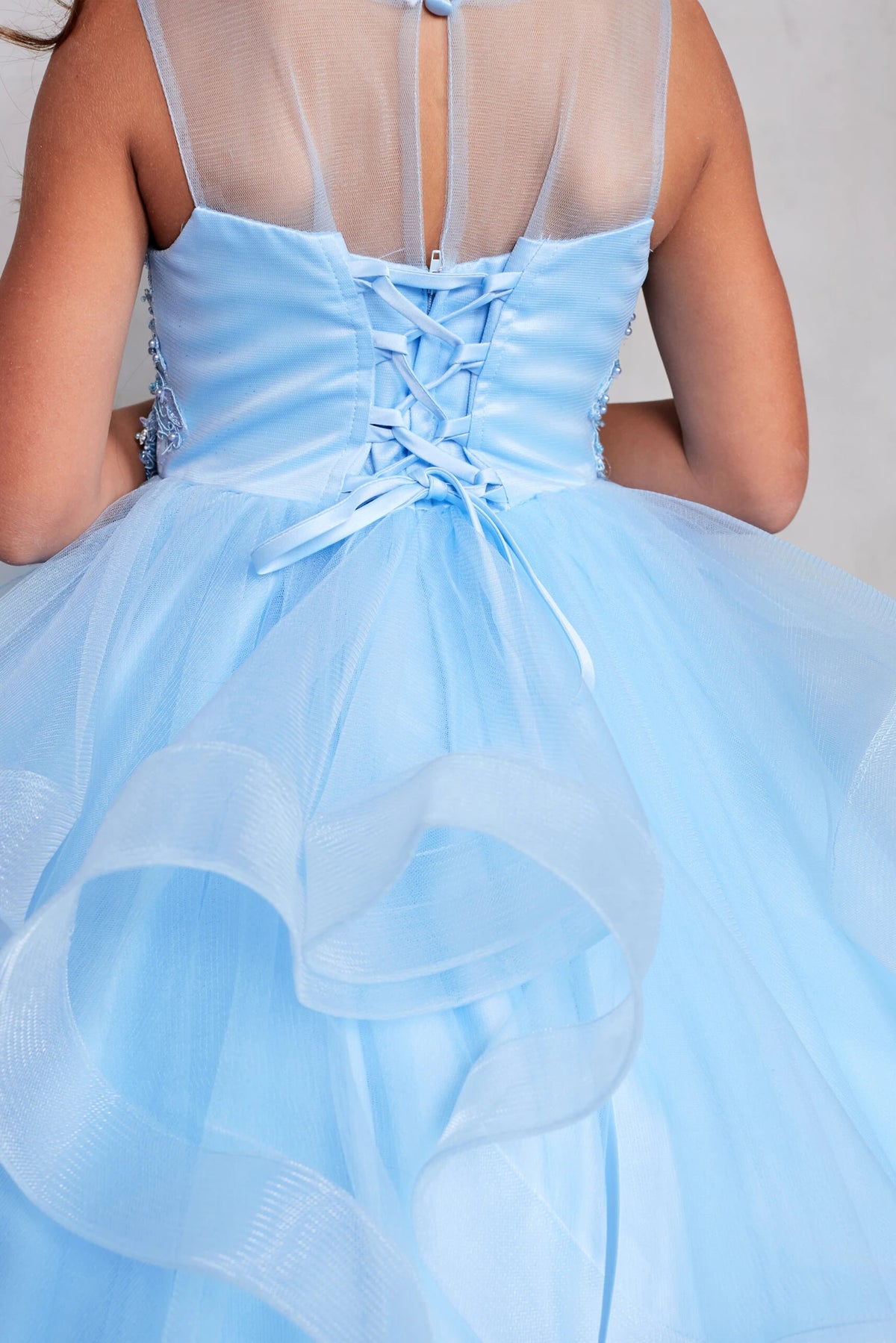 Seen from up close, this Sky Blue kids pageant dress displays lacing at the back waist.