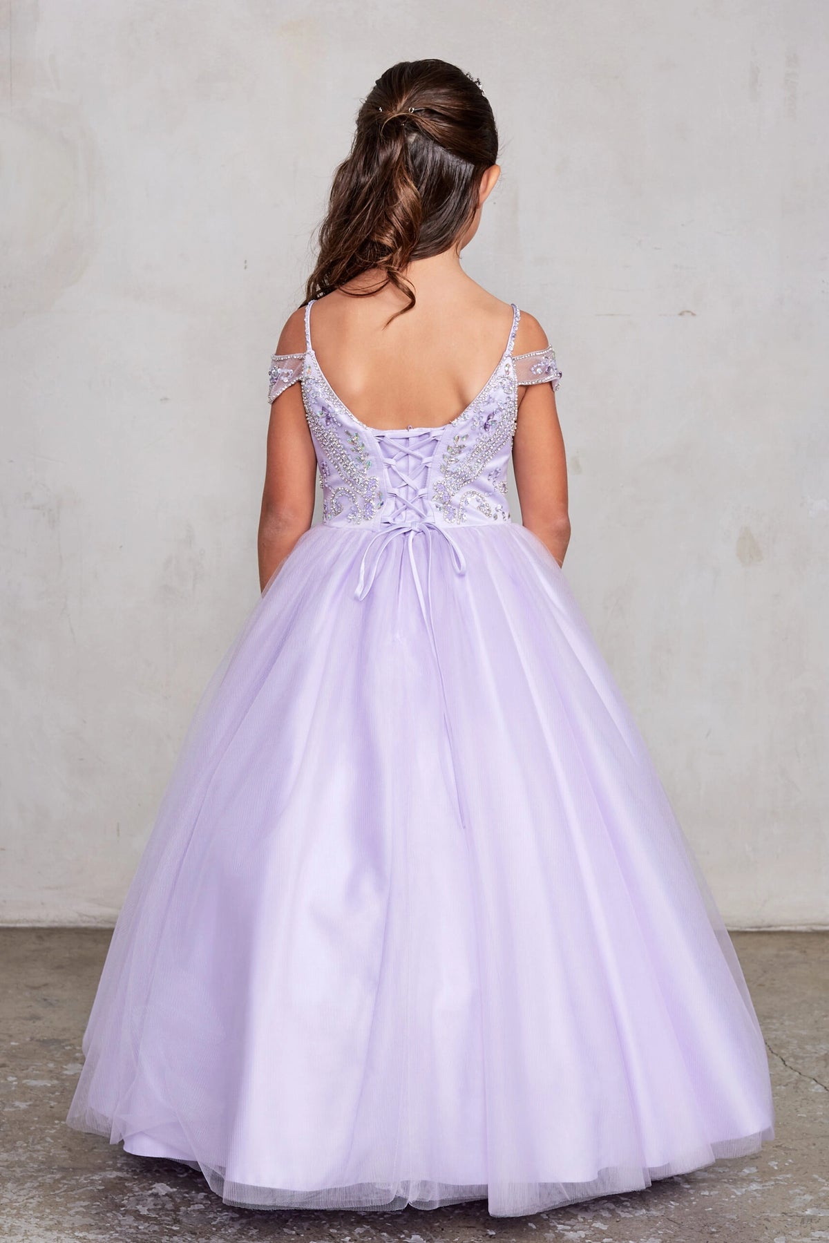 Lilac kids pageant dress featuring a tied sash across the back waist.