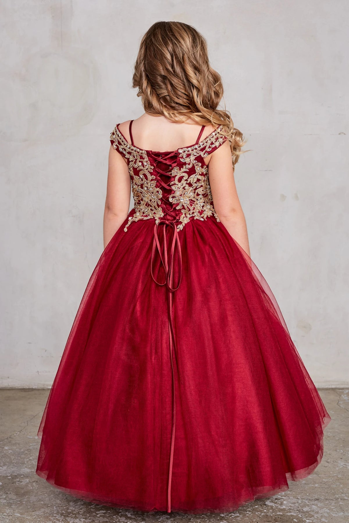 The Burgundy kids pageant dress has lace-up ties at the back.