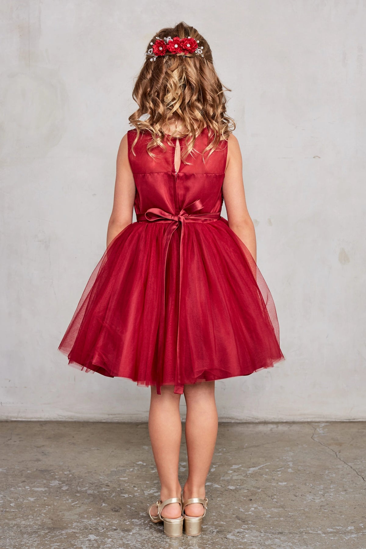 Burgundy kids pageant dress featuring a tied sash across the back waist.
