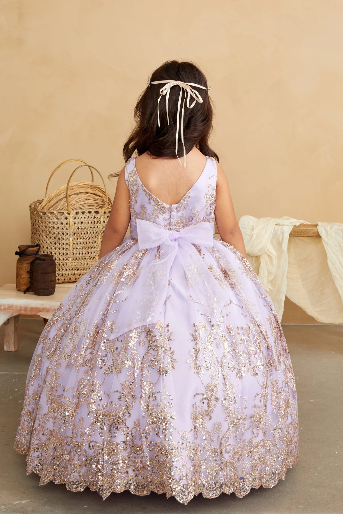 Lilac kids pageant dress featuring a tied sash across the back waist.