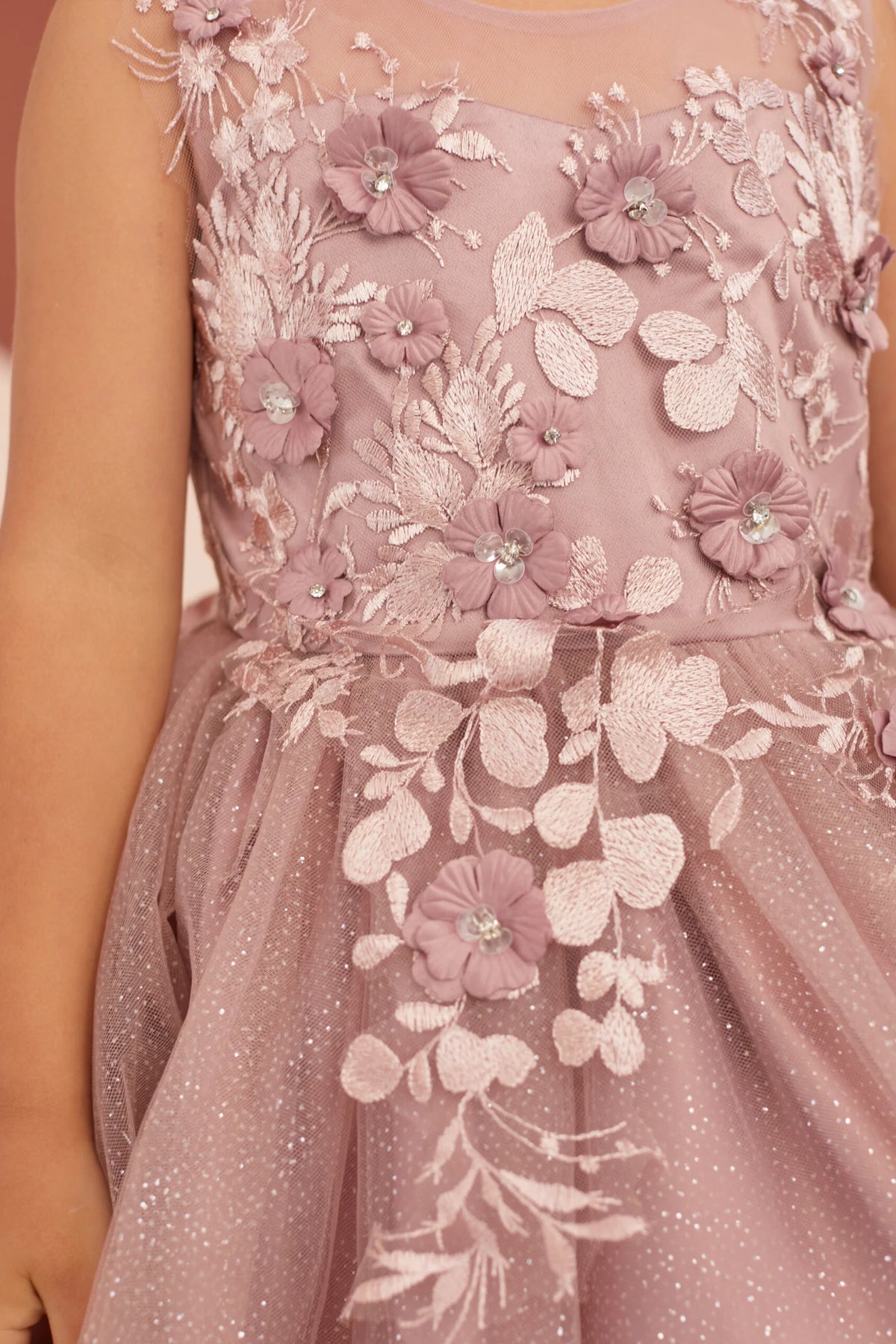 The Dusty Rose kids pageant dress has raised flower petals on floral lace.
