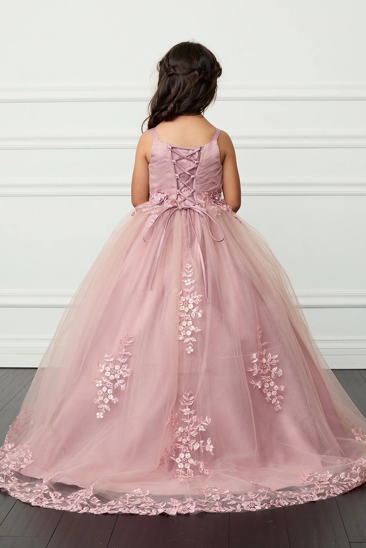The Dusty Rose kids pageant dress has lace-up ties at the back.