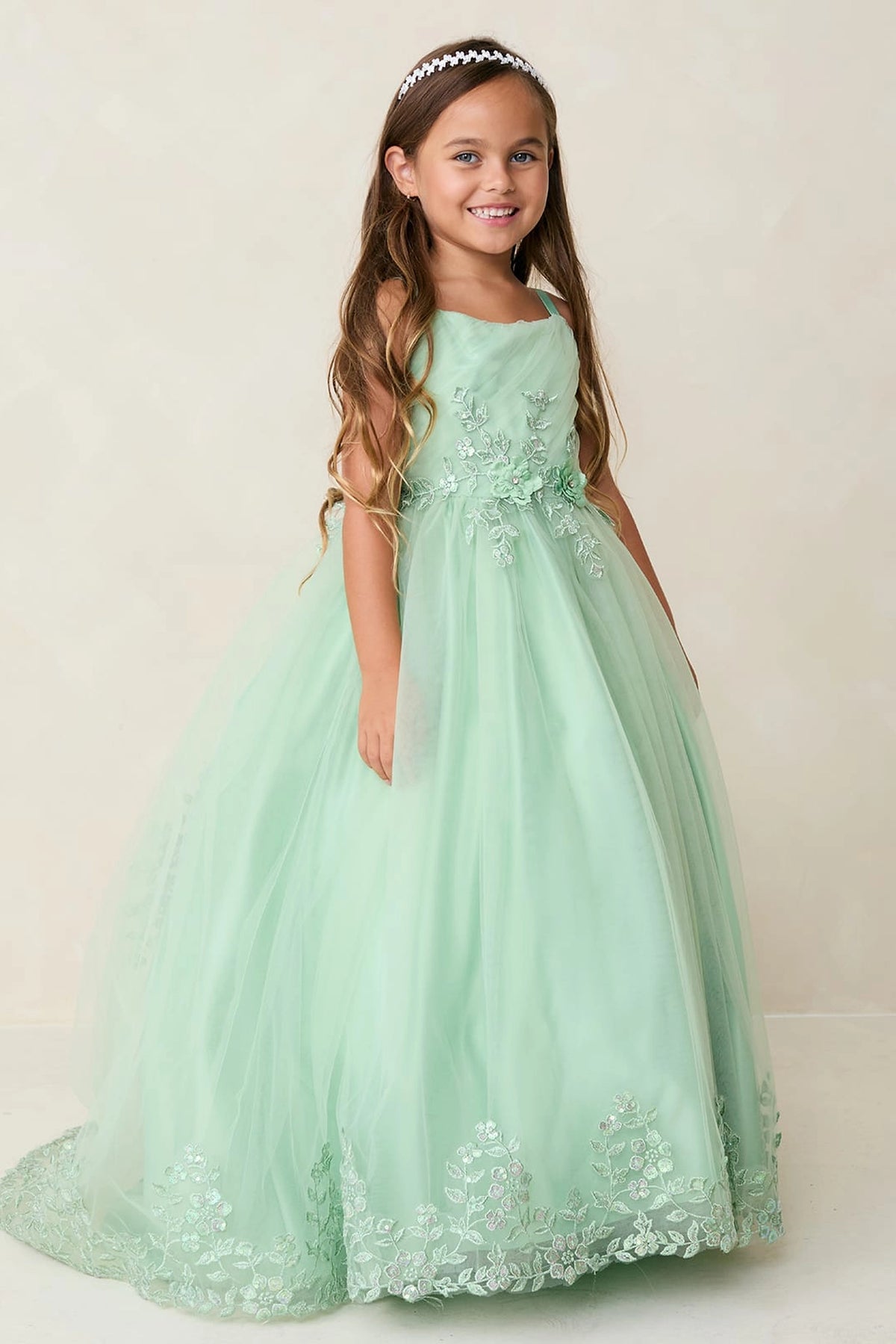 Sage kids pageant dress featuring lace trimming along a flowing train.