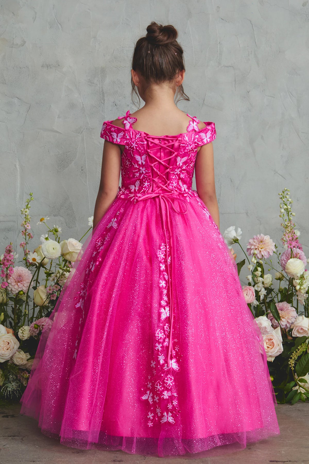 The Fuchsia kids pageant dress has lace-up ties at the back.