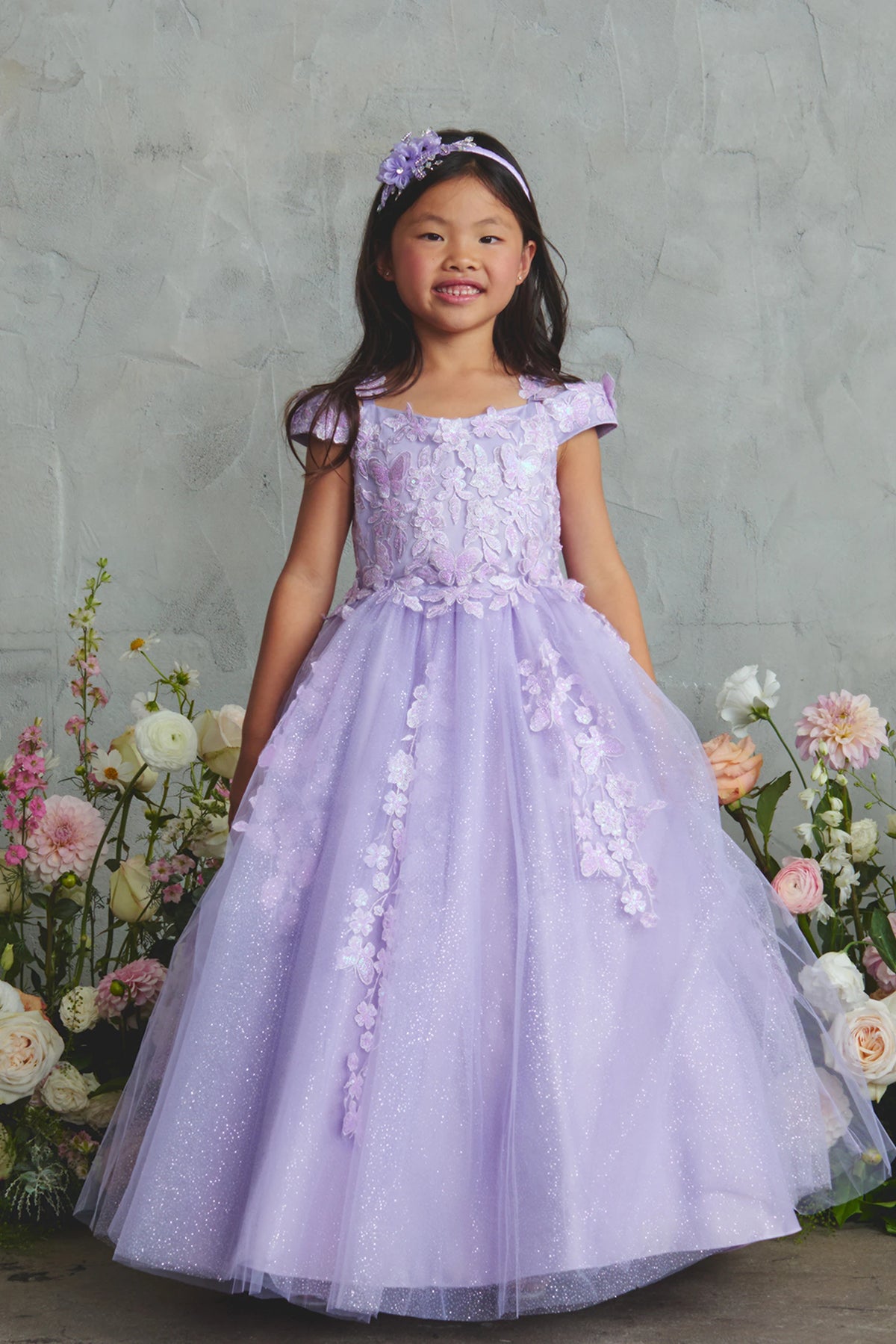 Lilac kids pageant dress featuring floral lace and butterfly accents.