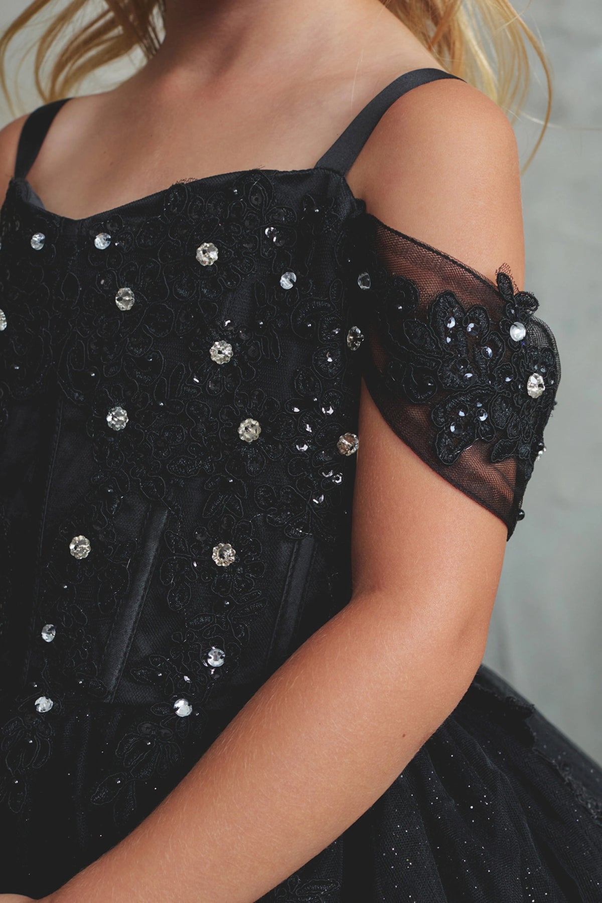 On the Black kids pageant dress, the detailing includes beaded lace along the neckline.