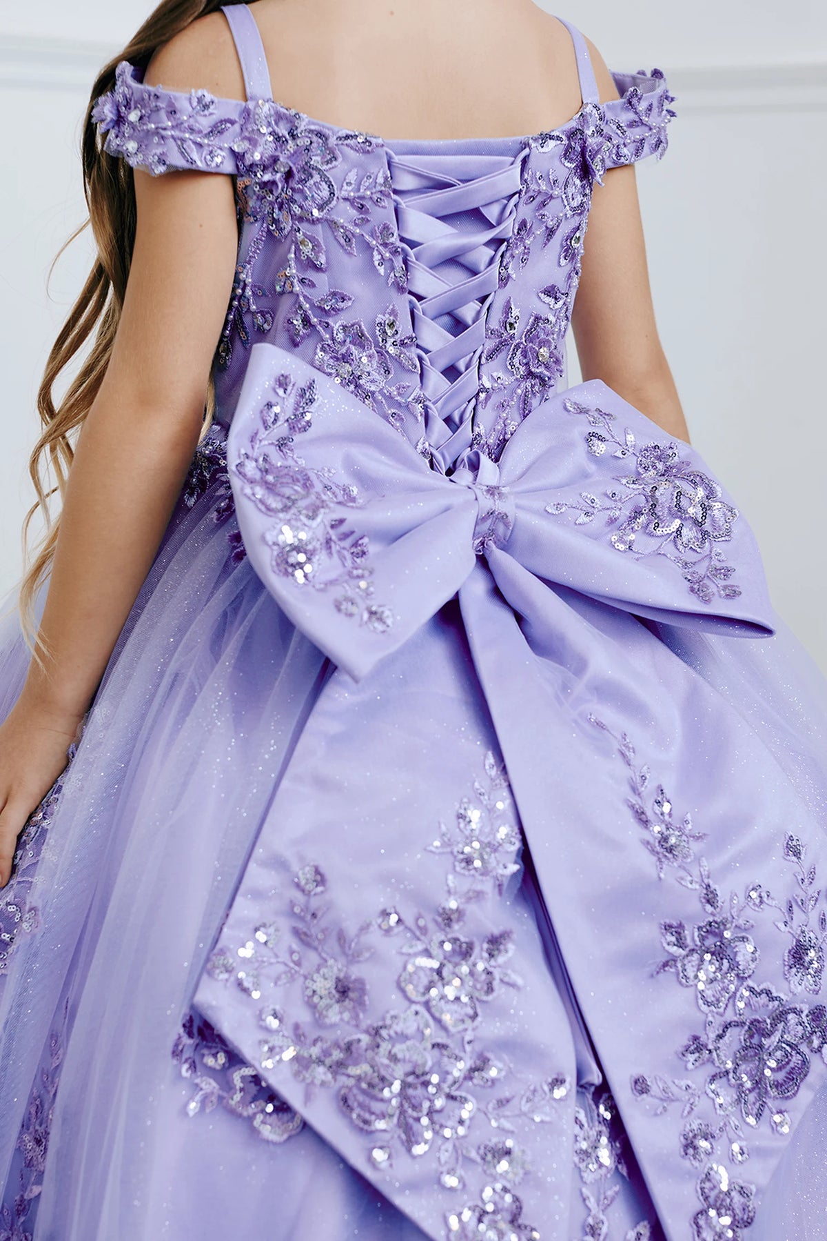 Visible details on the Lilac kids pageant dress include a large bow beneath the back lacing.