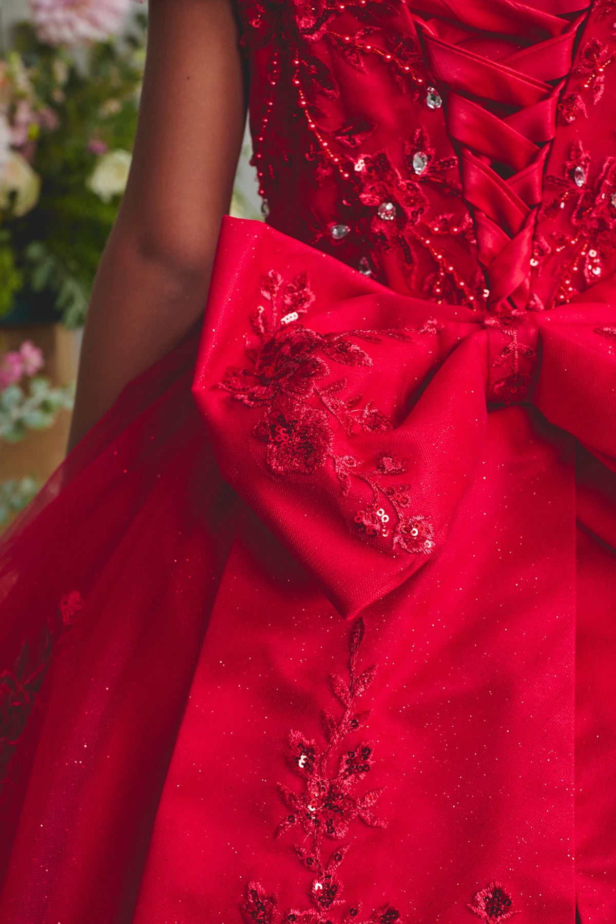 Seen from up close, this Red kids pageant dress displays a glittering bow at the back waist.