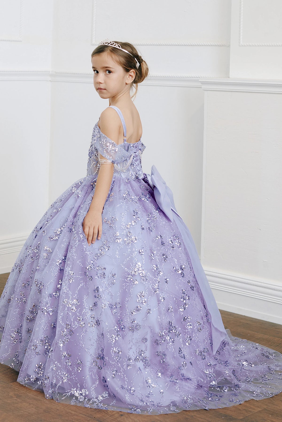 The Lilac kids pageant dress has beadwork over sheer bodice panels.