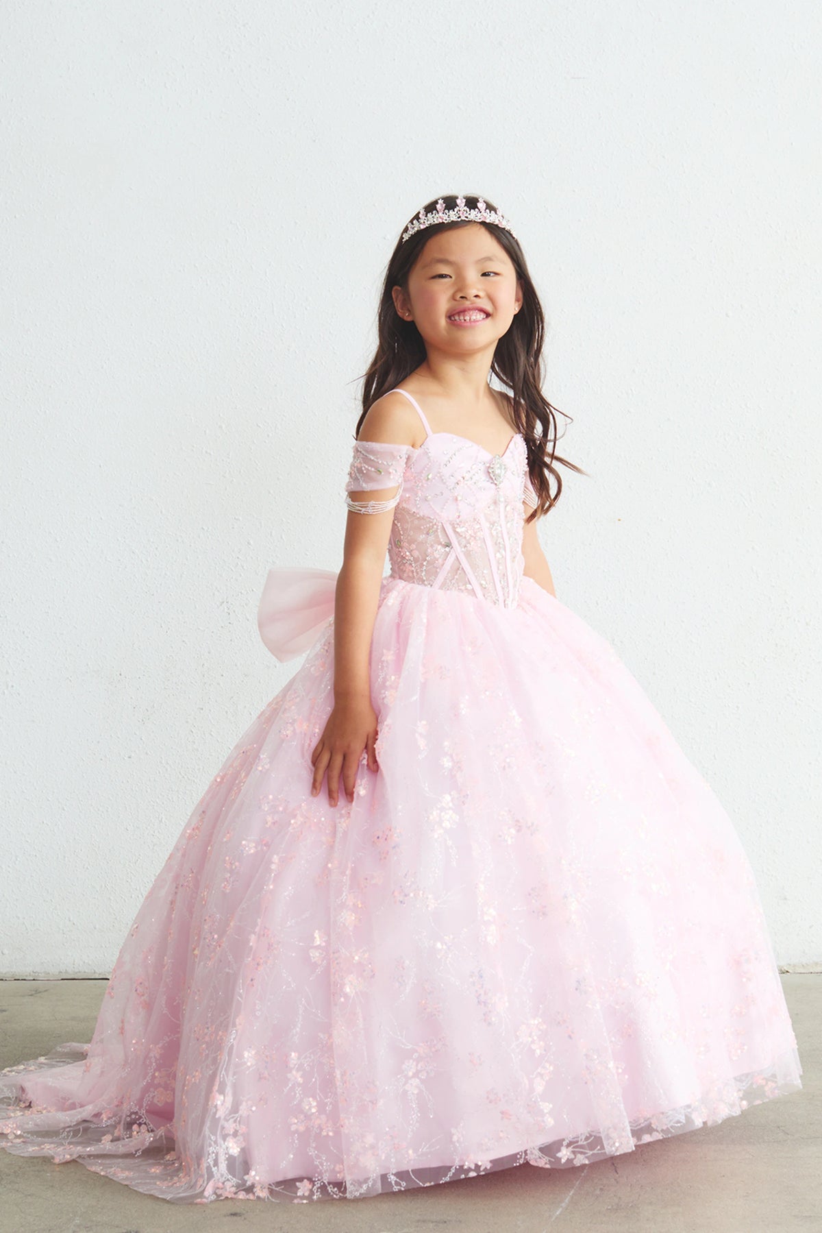 On the Pink kids pageant dress, the detailing includes beadwork over sheer bodice panels.