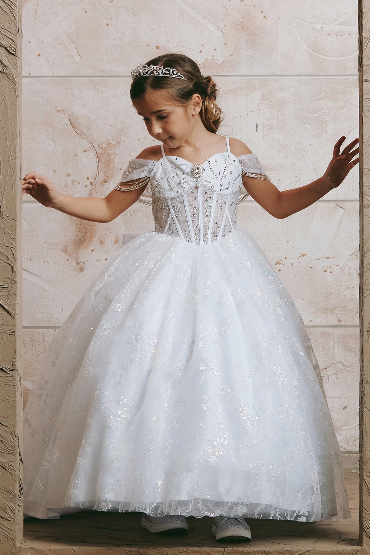 On the White kids pageant dress, the detailing includes beadwork over sheer bodice panels.