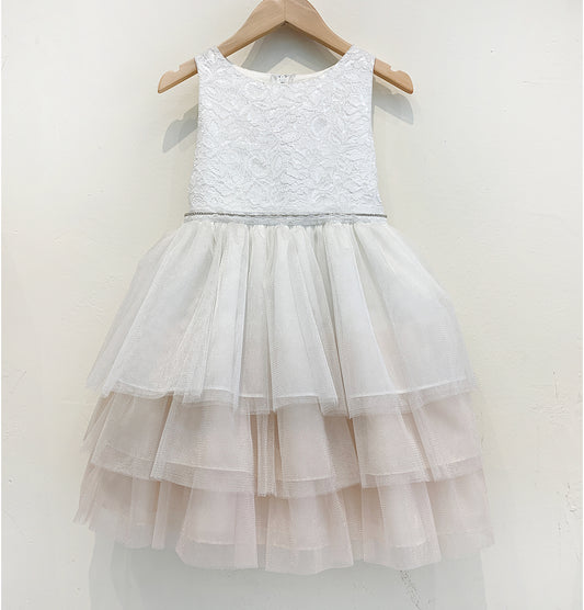 White lace dress with a layered tulle skirt on a hanger against a white background