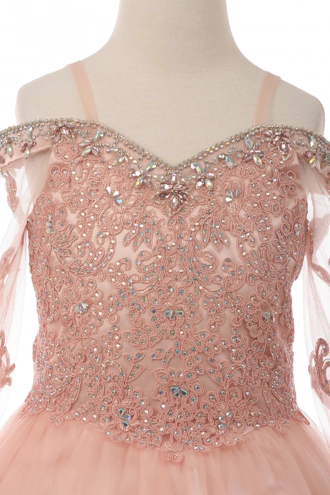 Rhinestones detail of a blush kids mini quinceanera dress with AB stones glitter tulle fabric and scattered floral appliques
