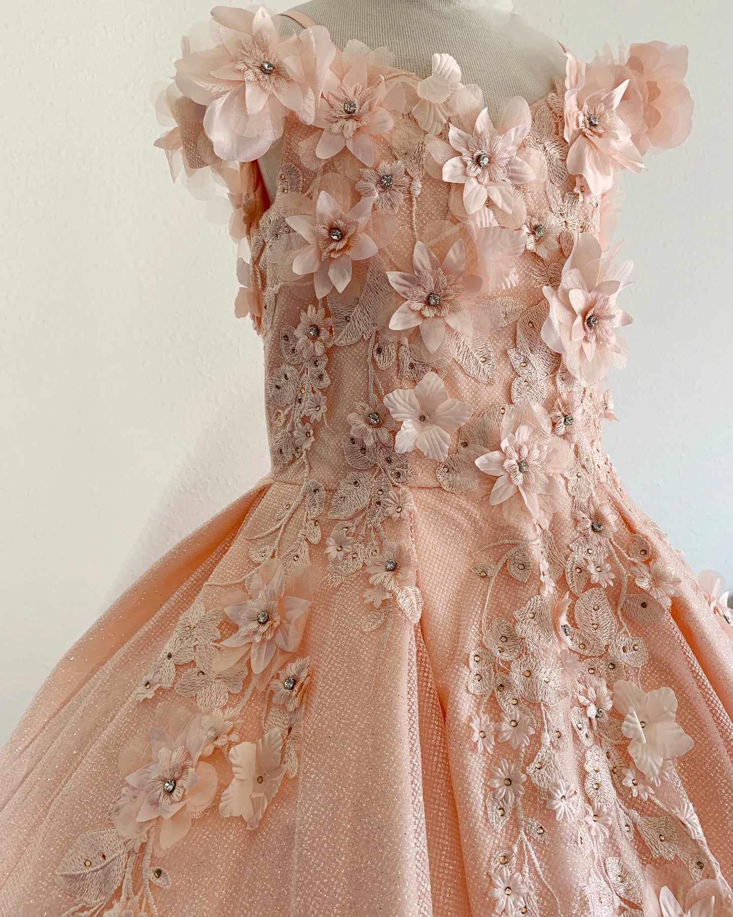 Peach blush front view kids mini quinceañera mini quince dress with floral lace embroidery and satin tulle fabric.