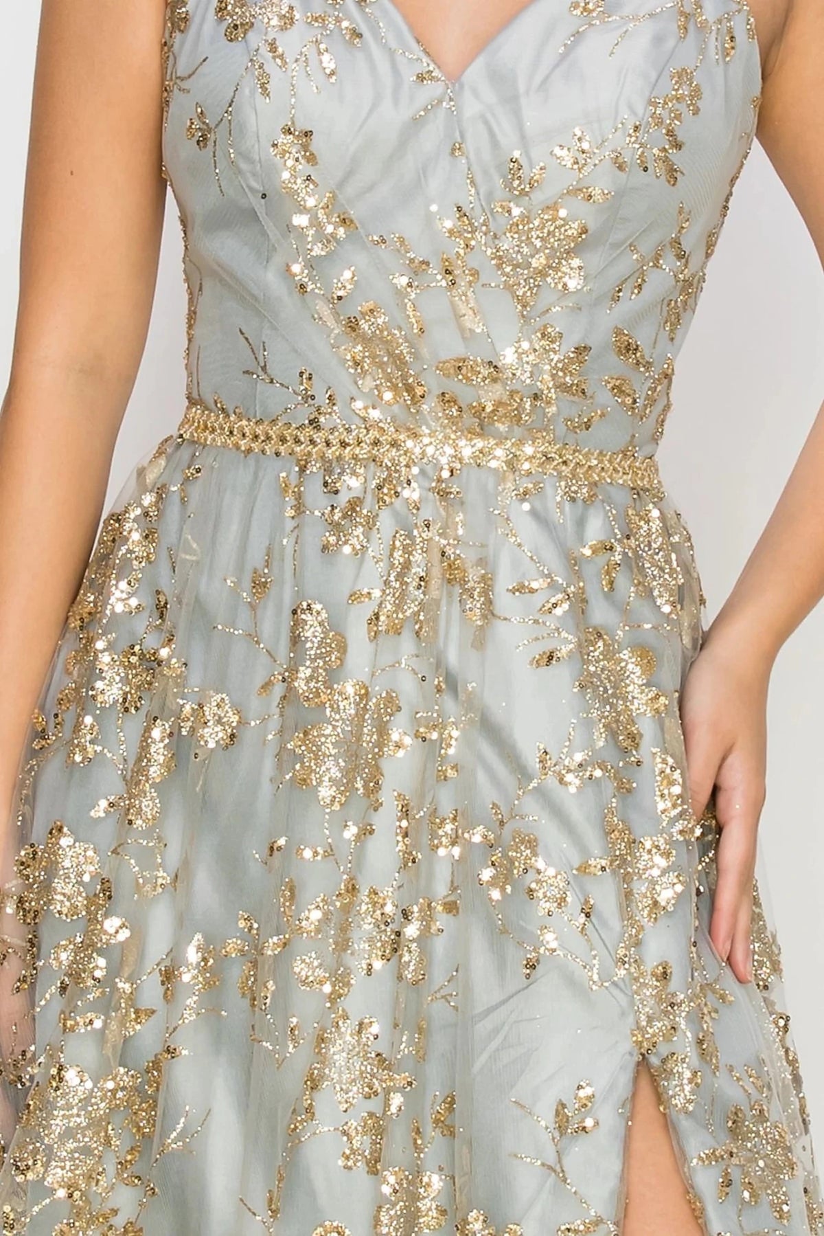 Detailed view highlights silver evening gown styled with beaded thin belt waistline silhouette.