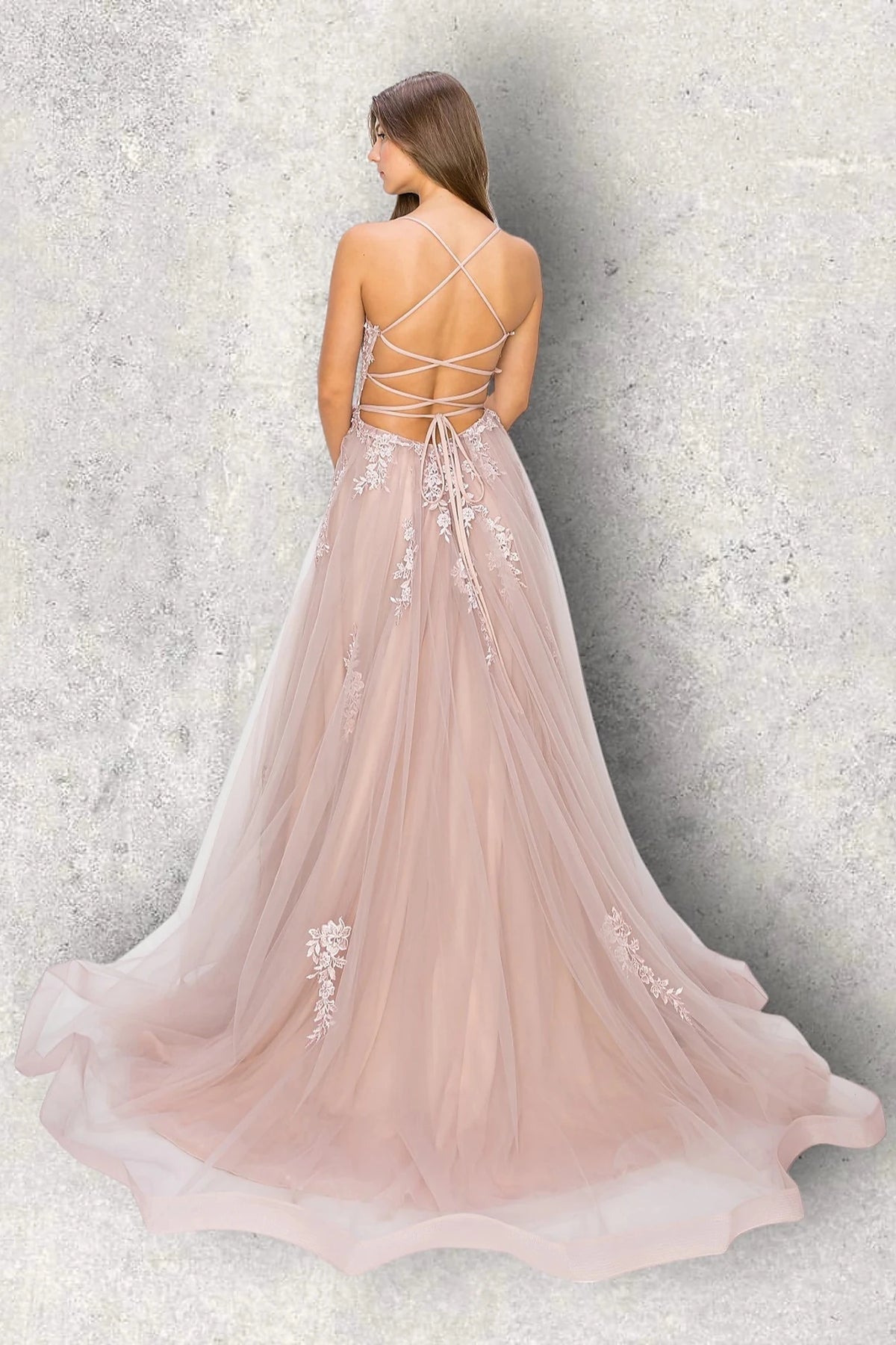 Rear view reveals mauve evening dress featuring thin straps and crisscross open back.