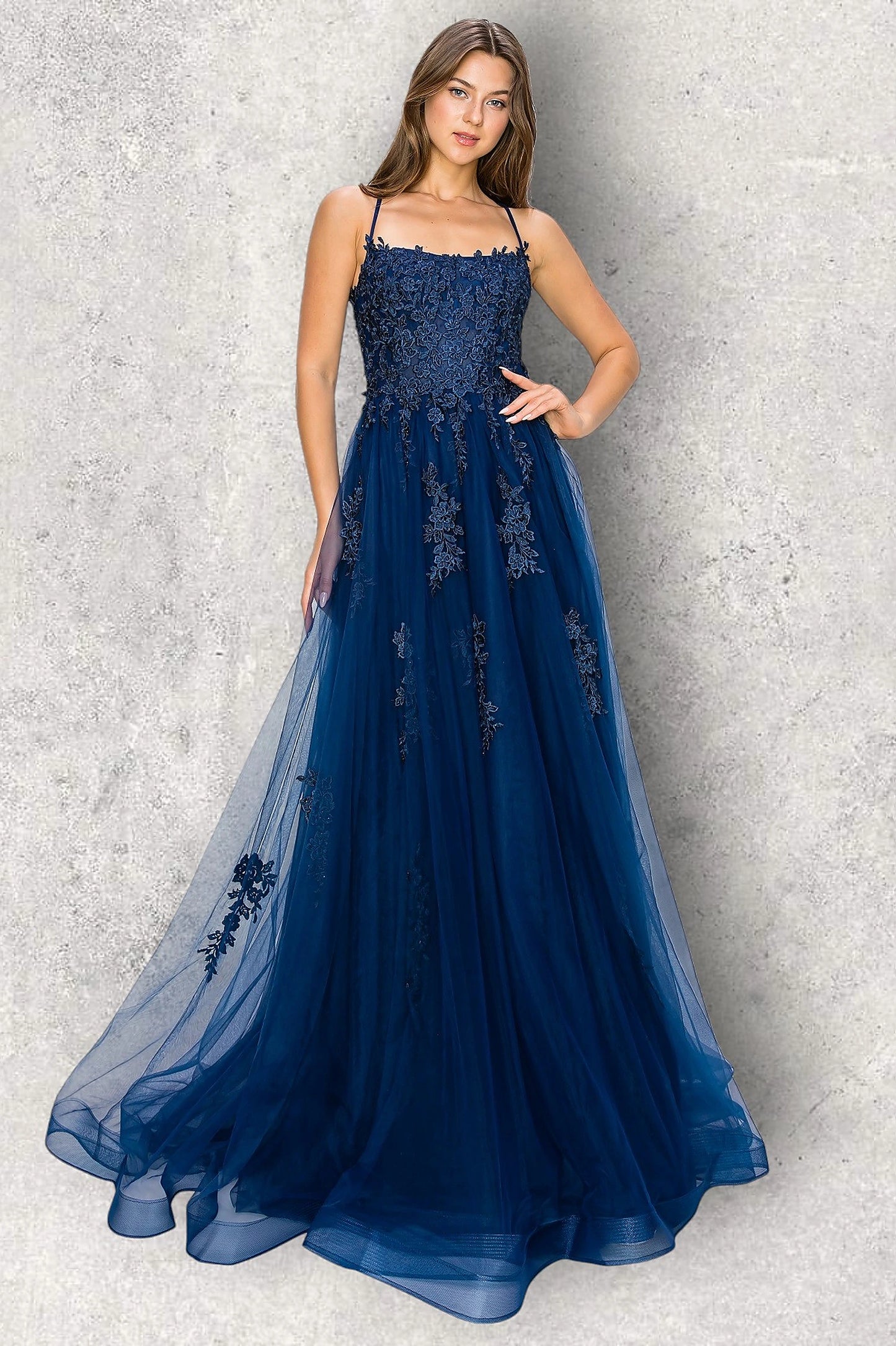 Navy evening dress completed with cascading floral appliques on skirt