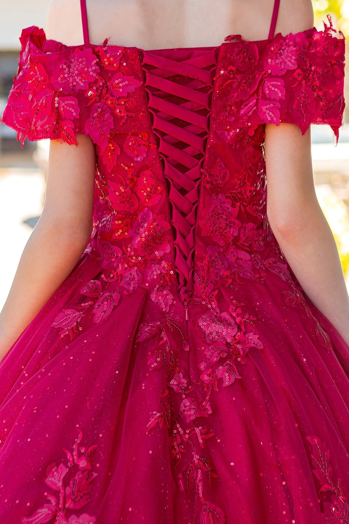 Red fabric close-up kids mini quinceañera mini quince dress with glitter lace layers, 3D floral sequin applique and embroidery accents.