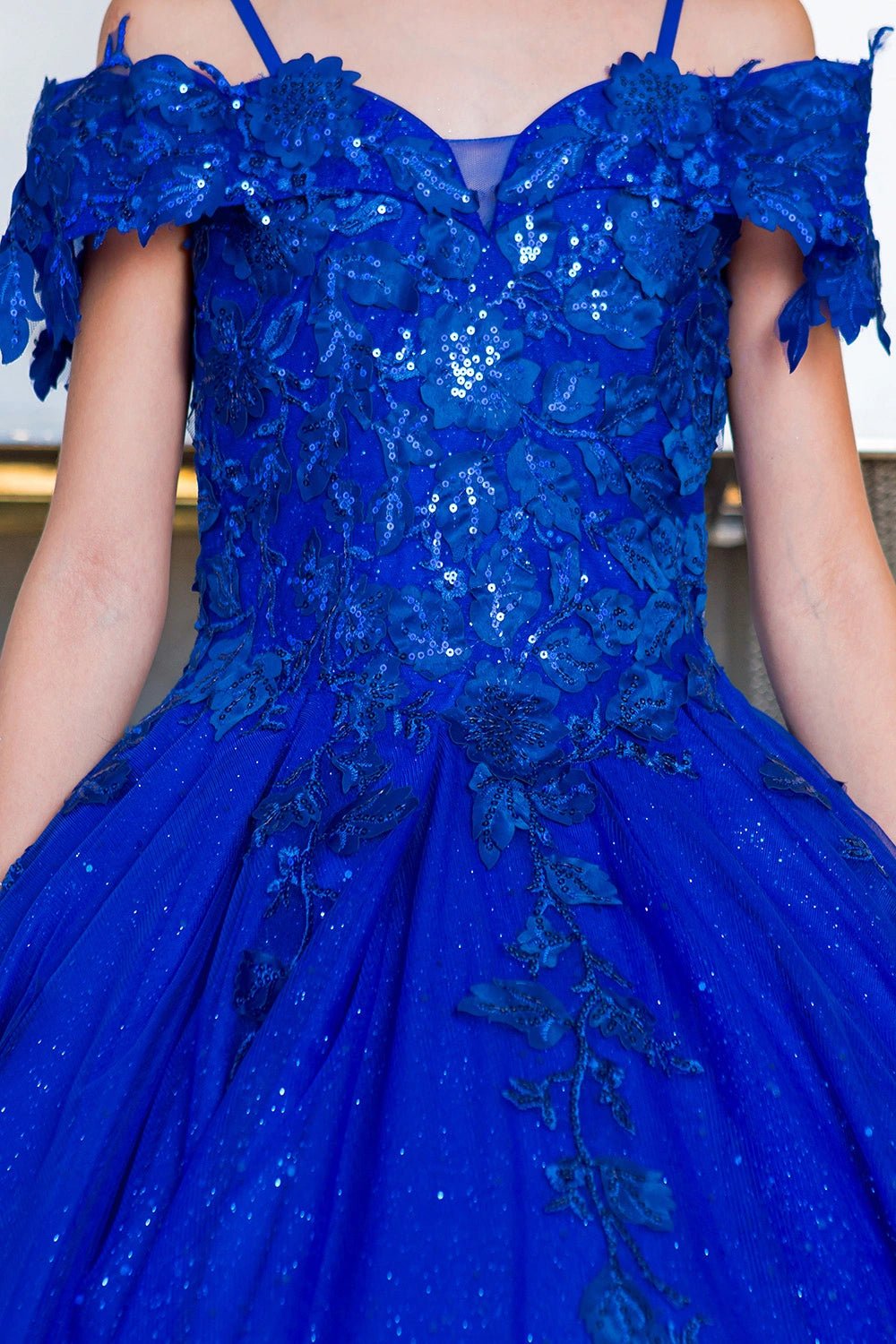 Shown in a bodice detail, the Royal Blue mini quince dress has off-shoulder floral sequin bodice with a sweetheart neckline.