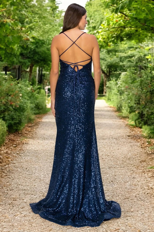 A full-length view of a woman wearing navy formal dress with lace-up corset closure.