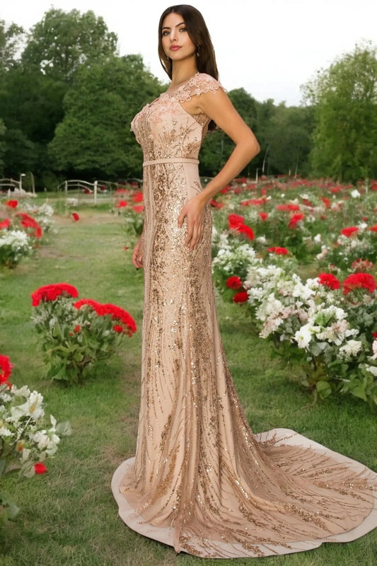 A full-length view of a woman wearing rose gold formal prom dress with open back detail.