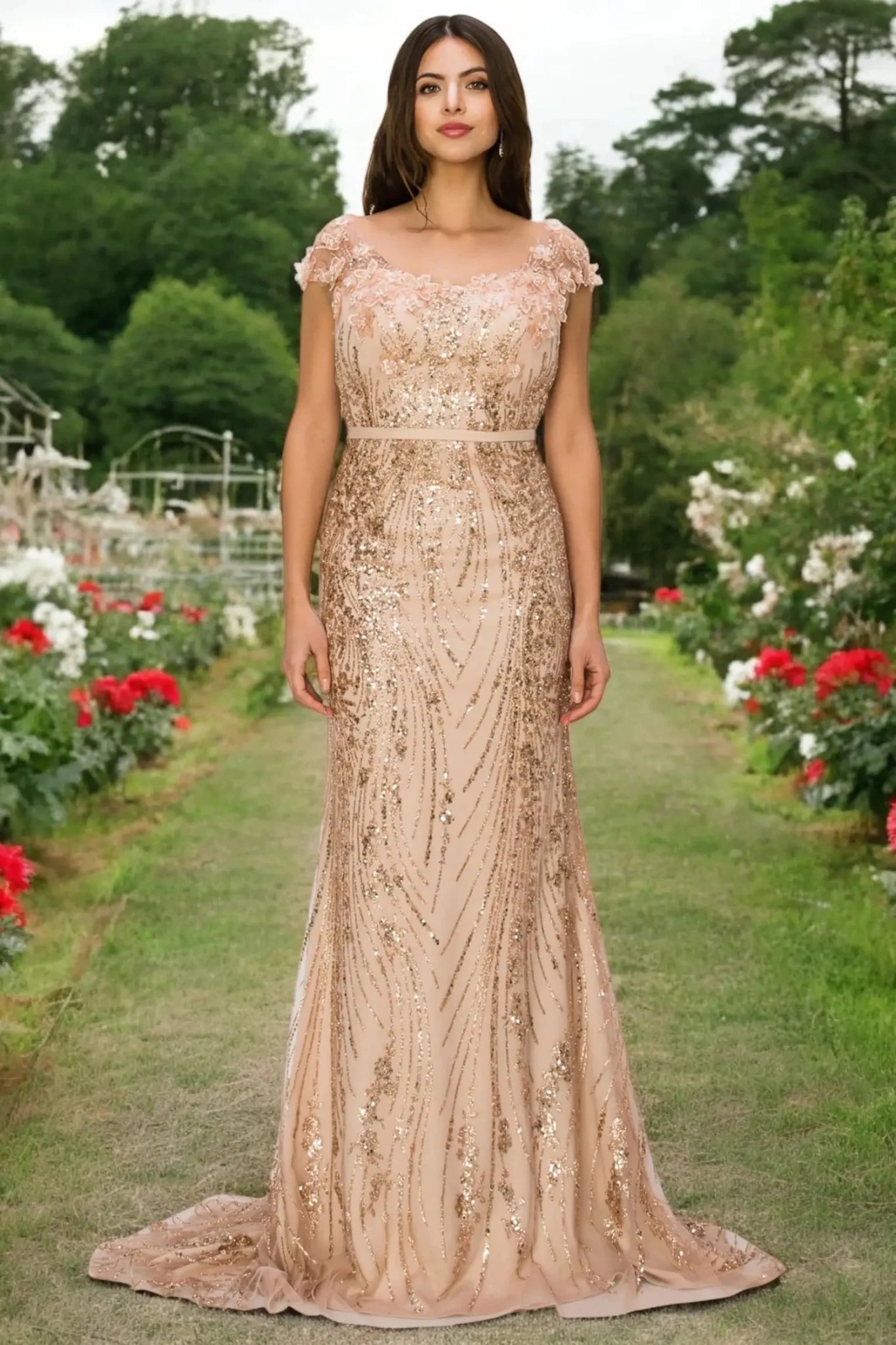 A full-length front view of a woman wearing a rose gold formal prom dress with an open back detail.