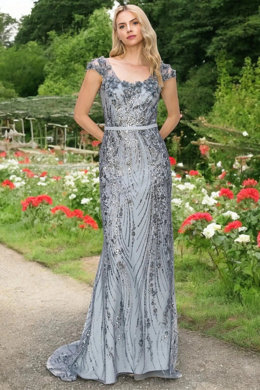 A full-length view of a woman wearing blue formal dress with an open back design.