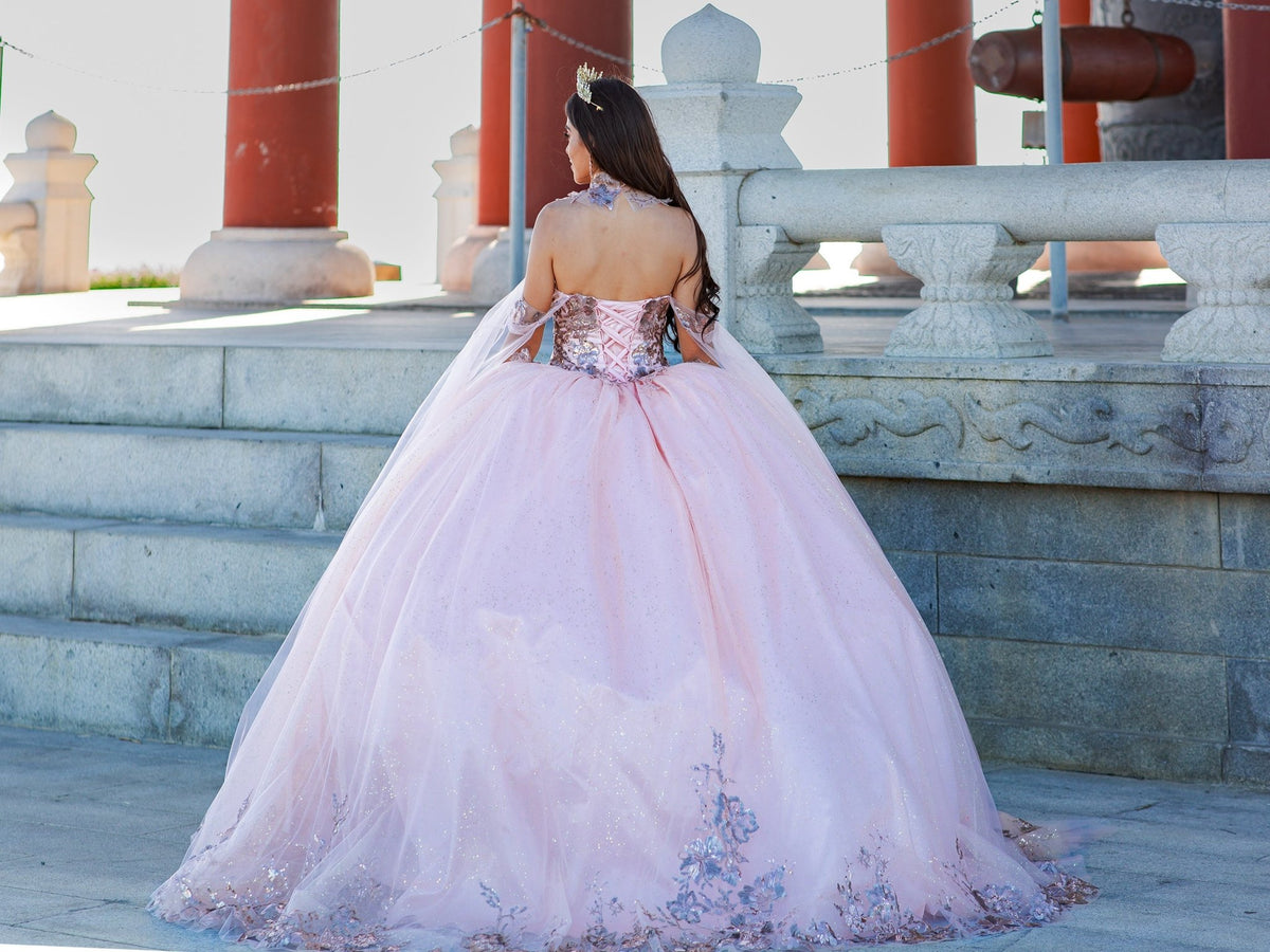 Rear view reveals blush quinceanera ball gown with golden lace, detachable shoulder train sleeves, and lace-up closure.