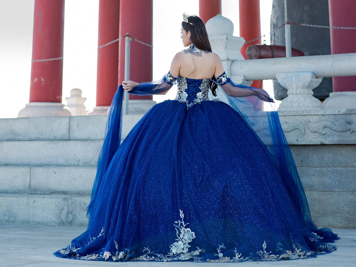 Rear view reveals navy quinceanera ball gown with golden lace, detachable shoulder train sleeves, and lace-up closure.