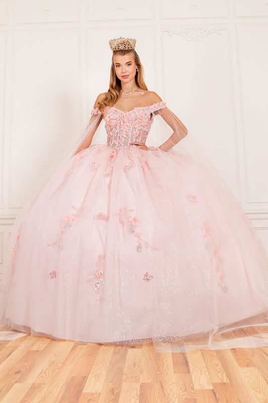 a girl wearing a blush butterfly applique quinceanera dress in a studio