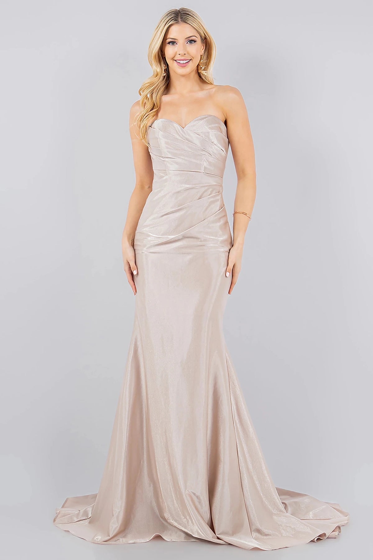 Decorative elements define champagne prom dress showcasing mermaid silhouette with floor-length skirt.