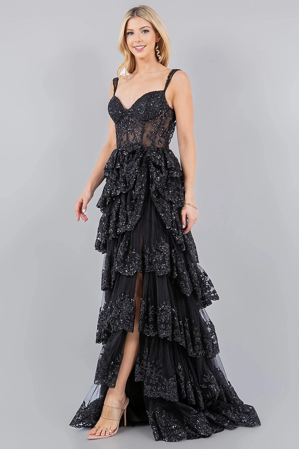 Textured details appear across black evening dress completed with floor-length silhouette and sweep train.