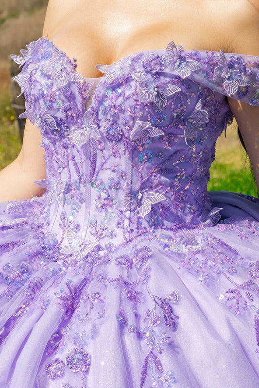 Close-up of a top part of a lilac ball gown with floral and butterfly details.
