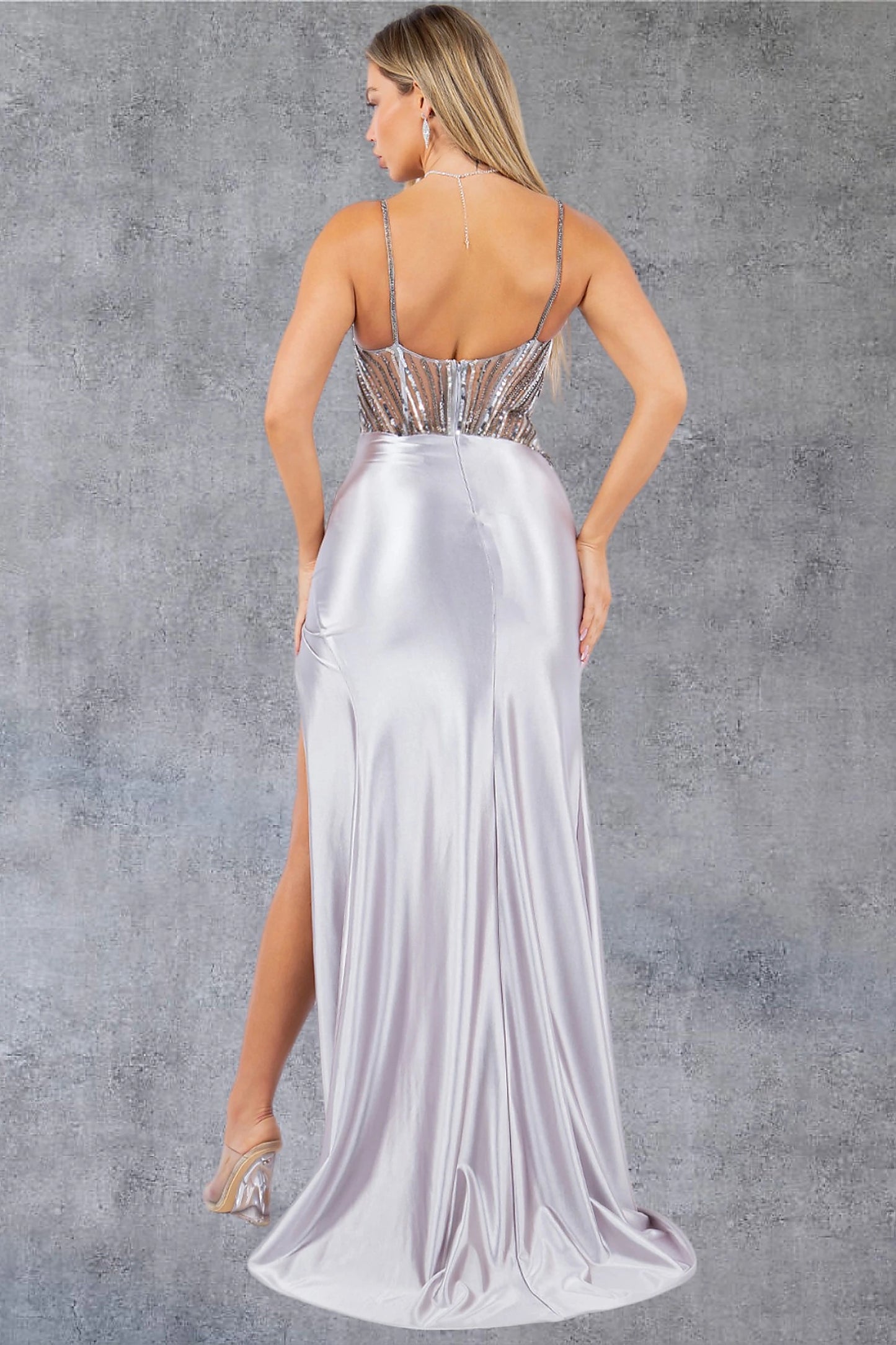 Silver prom dress completed with open back construction and zipper closure