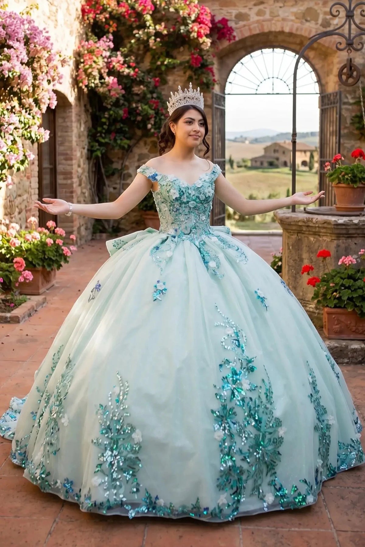 Bodice close-up highlights sage quinceanera ball gown with sweetheart neckline, floral beaded appliques, and seven-layer tulle skirt.