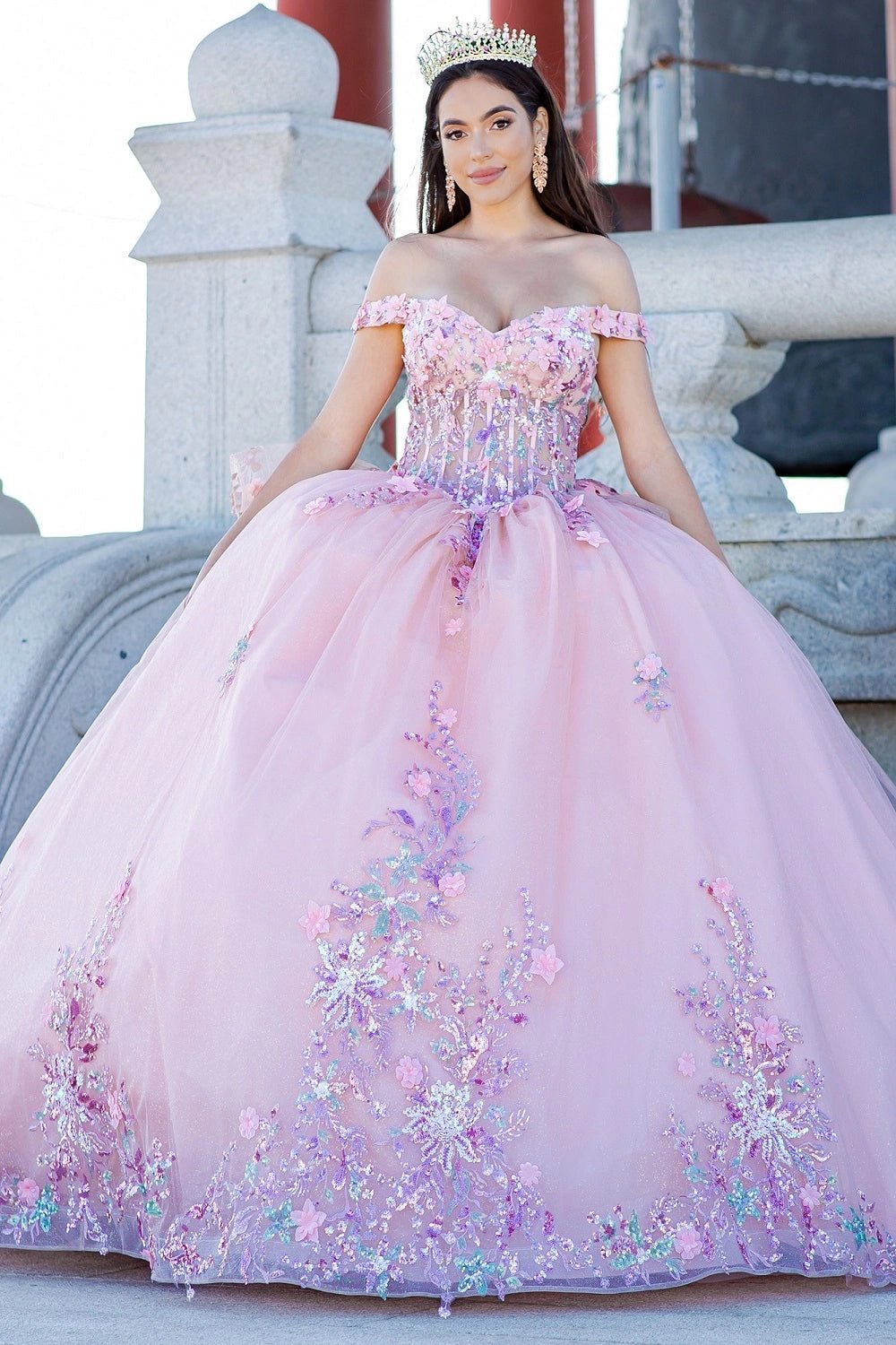 Shown in a full-skirt front view, the Peach Blush quinceañera dress has off-shoulder floral bodice and floral appliques across the ball skirt.
