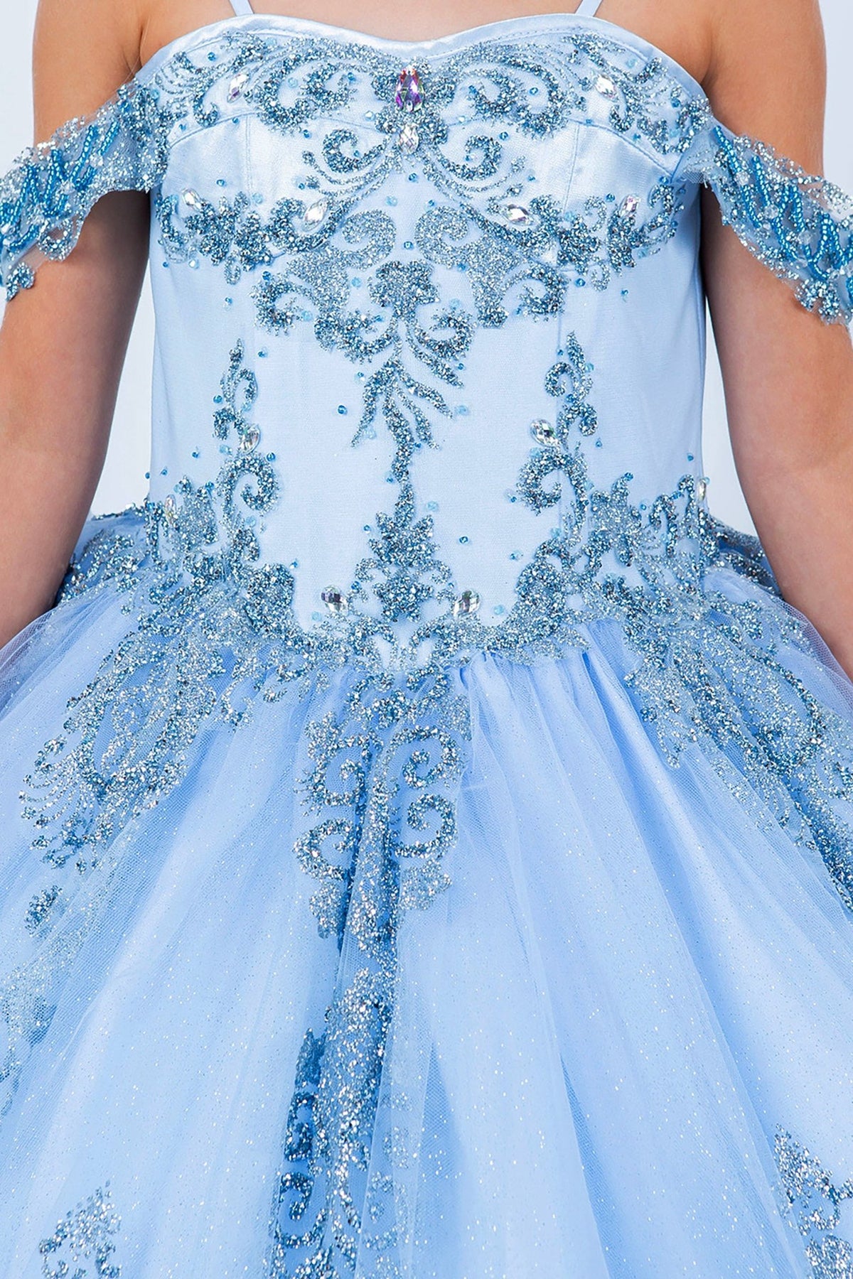 Close-up view reveals blue front zoom kids mini quinceañera mini quince dress with sparkle bead details and layered tulle skirt.