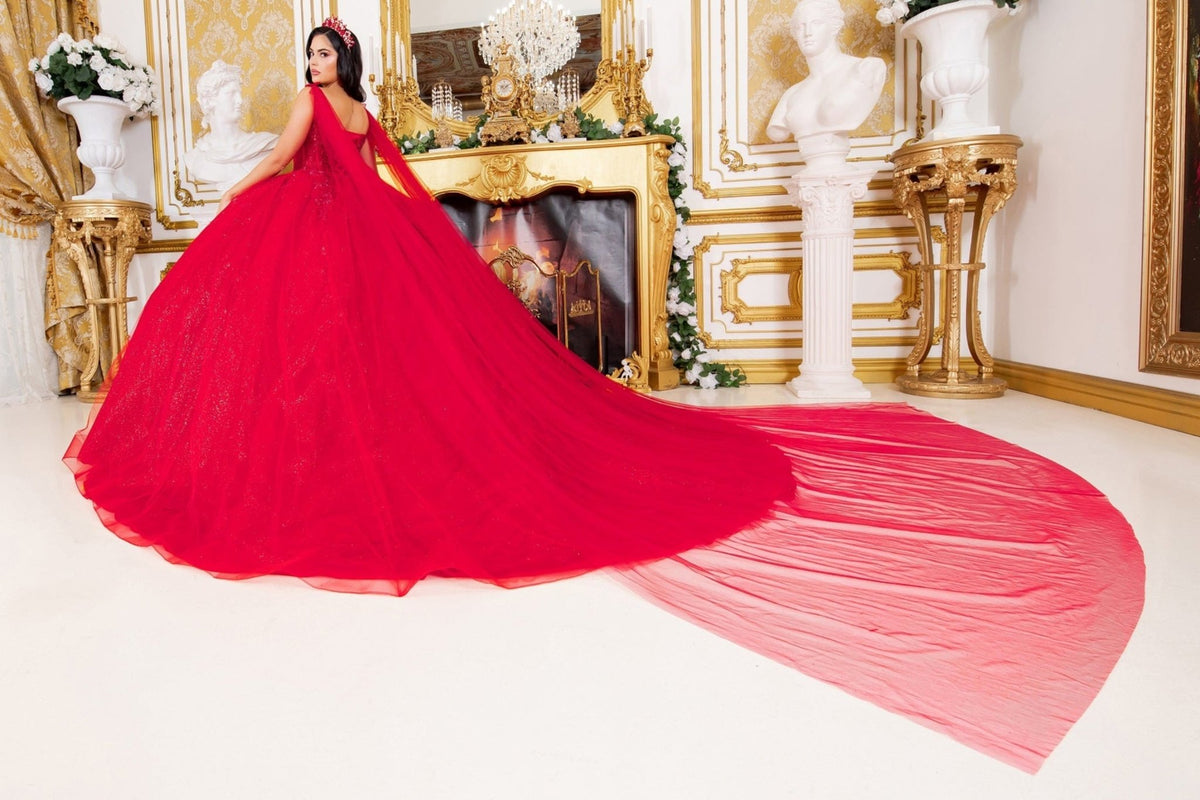 Side profile shows red quinceanera ball gown with floral embellishments, central brooch, and flowing sheer cape.
