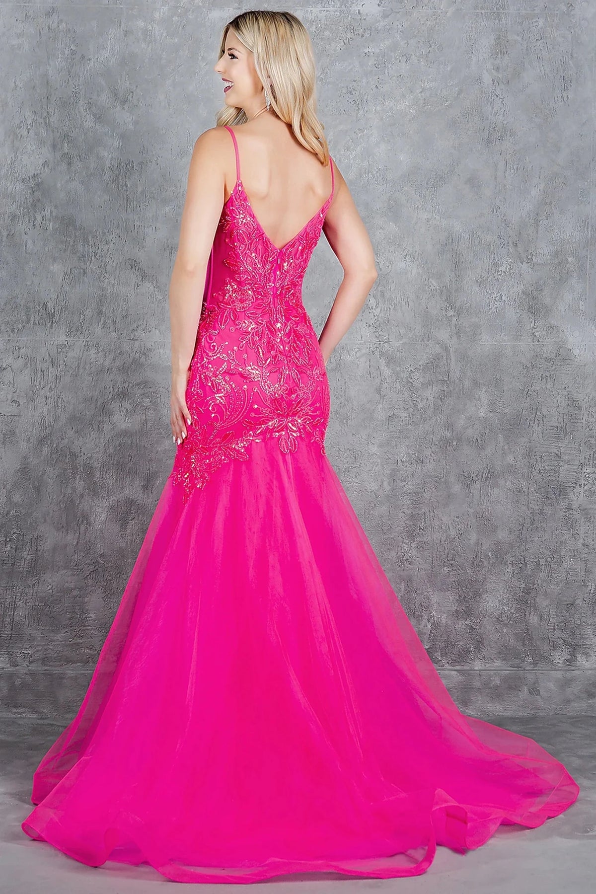Rear view reveals fuchsia tulle mermaid prom dress designed with low V-shape back and zipper closure.