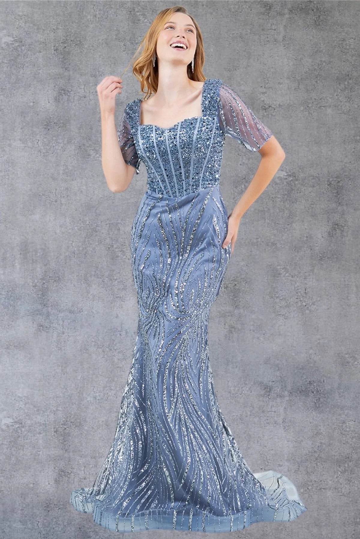 Luminous Dusty Blue mother of the bride mermaid dress features sheer sleeves and wave-pattern sequins.